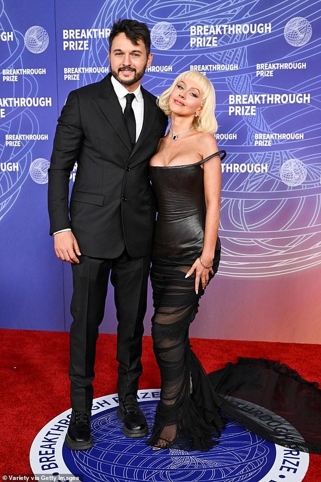 Christina Aguilera and fiance Matthew Rutler pose together in coordinating black looks at the Breakthrough Prize.