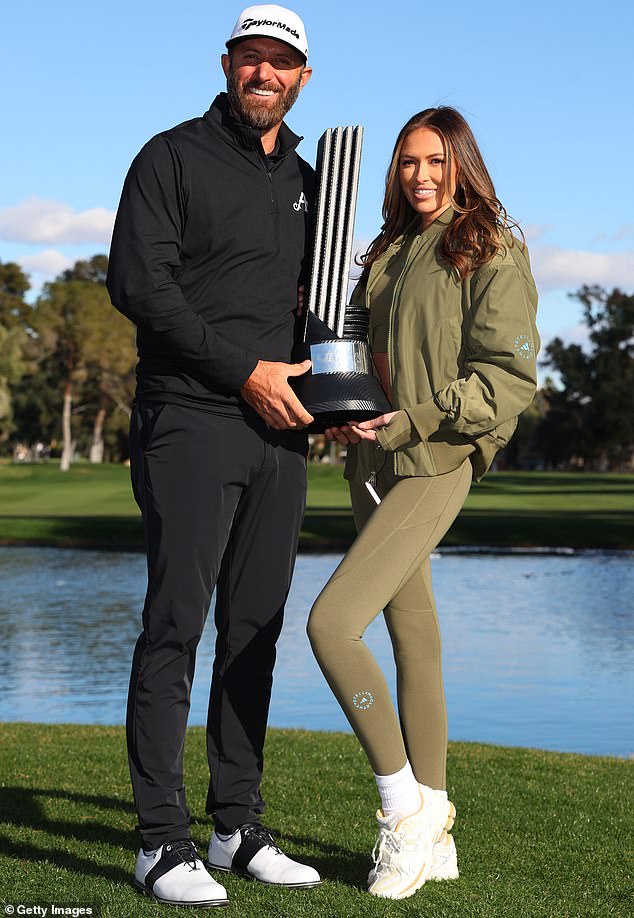 Dustin Johnson with Paulina Gretzky holding a trophy
