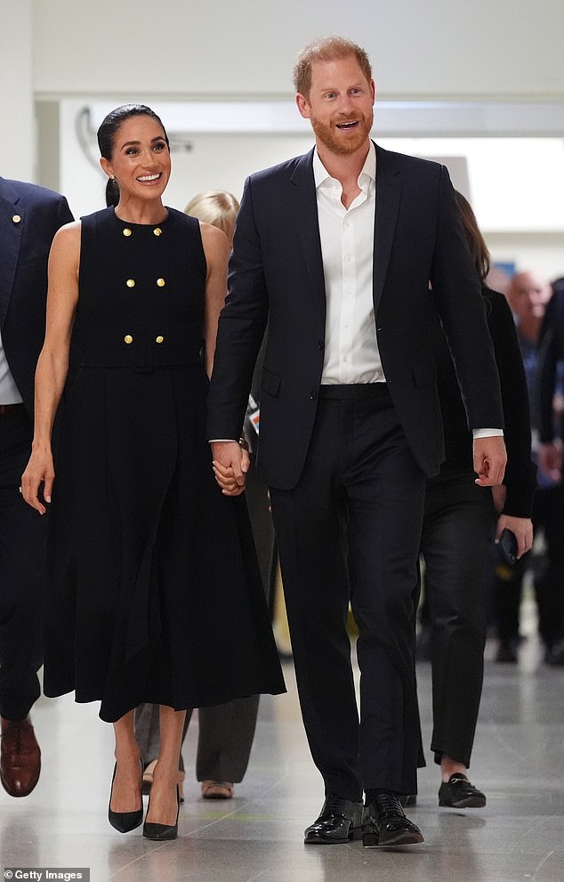 Meghan Markle wearing the white Karen Gee 'Priscilla' dress during visits to a Melbourne homeless shelter and children's hospital