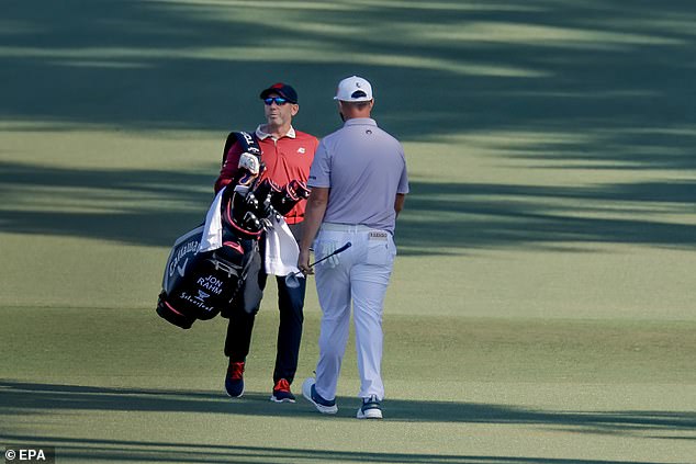 Sergio Garcia carries Jon Rahm's golf bag down the fairway during the final round.