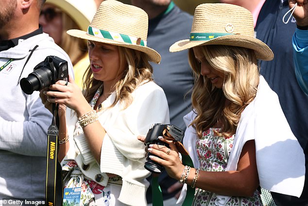 Patrons take photos during a Masters practice round, when cameras are permitted on the grounds.