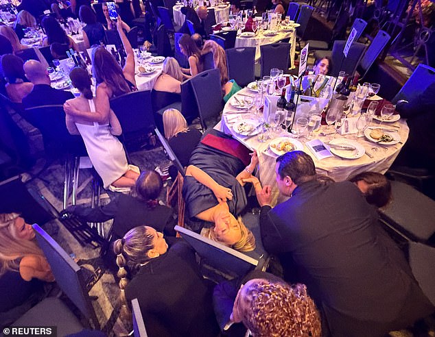 Guests take cover on the ballroom floor during the security scare at the Washington Hilton.
