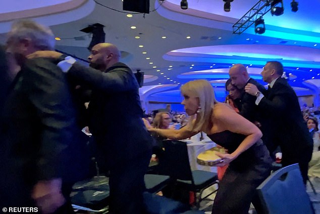 Robert F. Kennedy Jr and Cheryl Hines duck as they run for safety