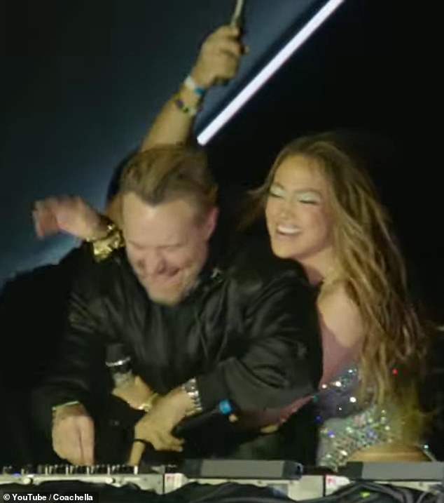 Jennifer Lopez embraces David Guetta in the DJ booth after performing Save Me Tonight.
