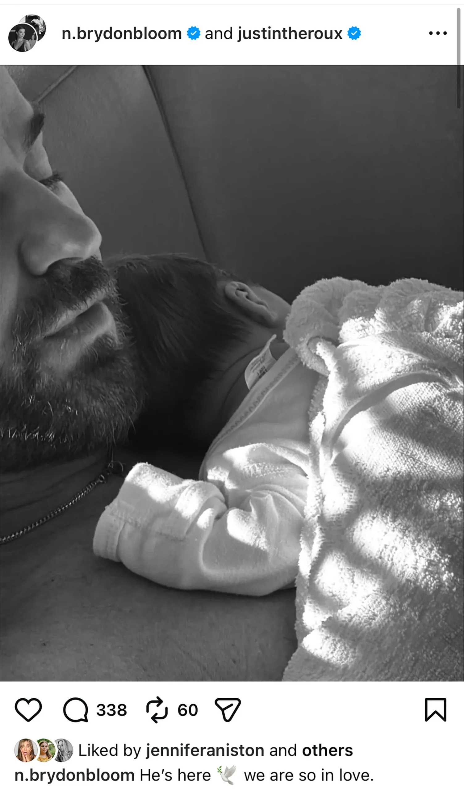 Justin Theroux cradling a newborn in a black-and-white Instagram photo that Jennifer Aniston liked.