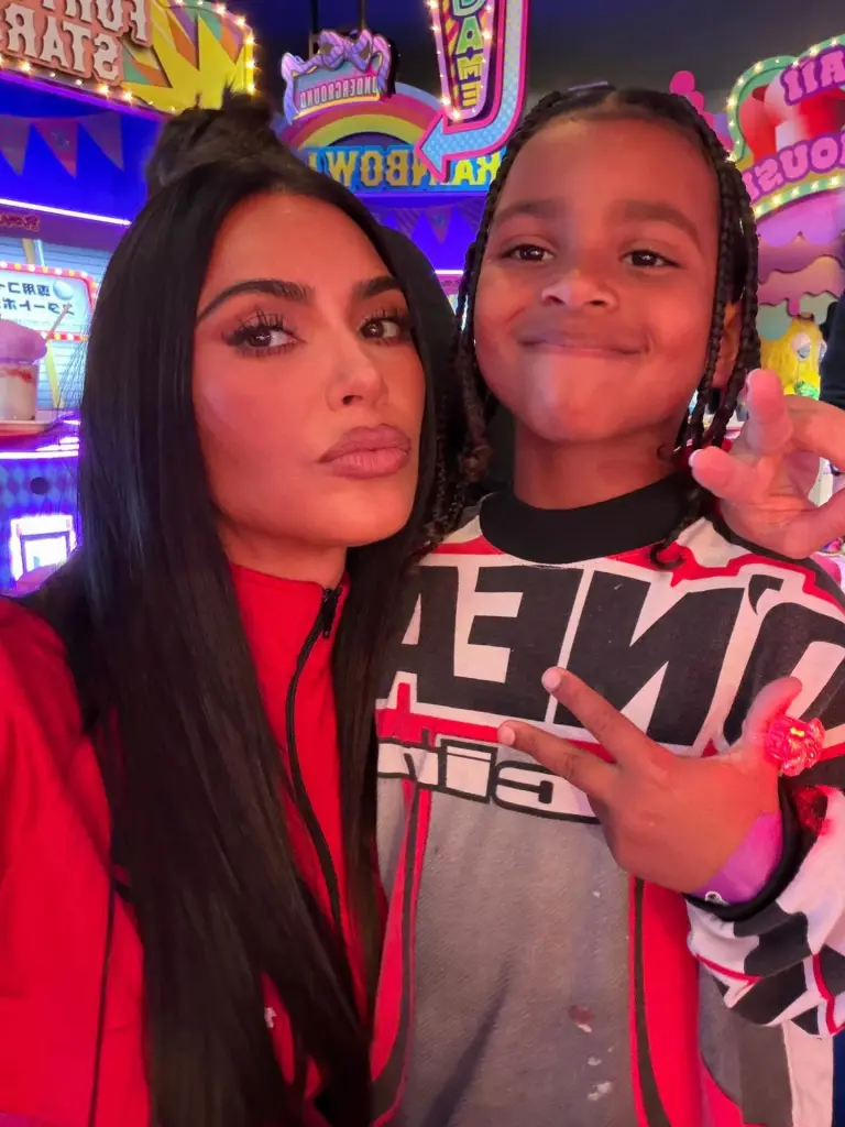 Kim Kardashian and a child posing for a photo.