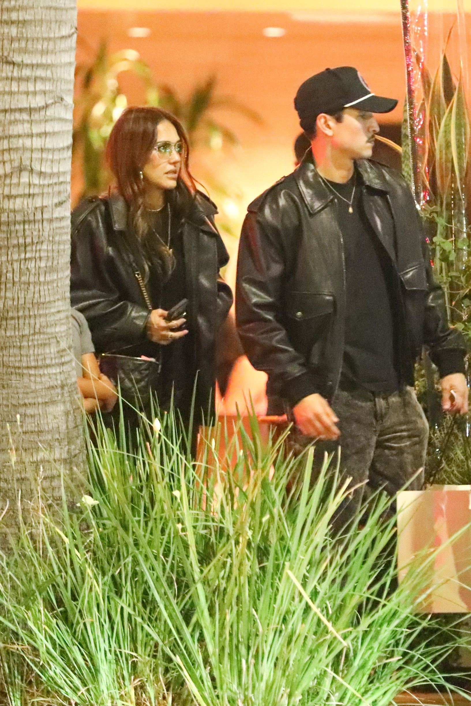 Jessica Alba and Danny Ramirez leave Avra restaurant in coordinating black leather jackets.