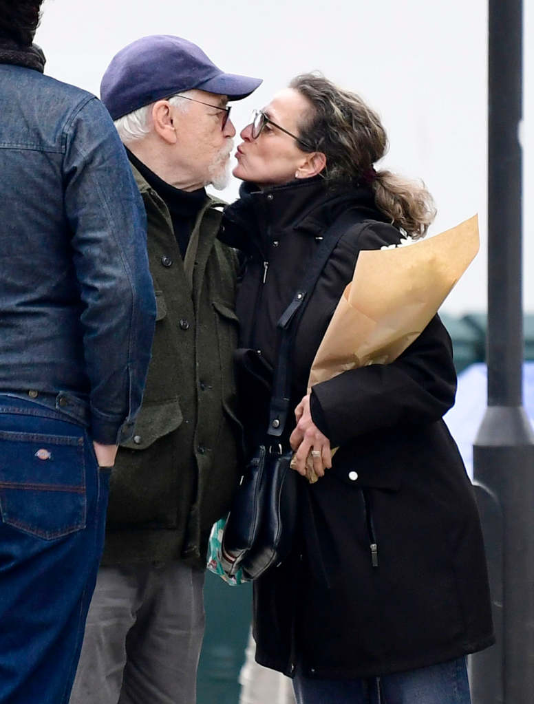 Brian Cox kisses Nicole Ansari-Cox goodbye on a North London street.