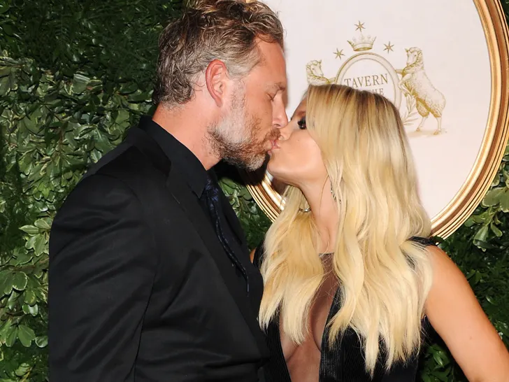 Jessica Simpson and Eric Johnson pose together at an event.