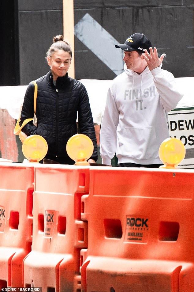 Jackman gestures animatedly while Foster walks beside him, lips pressed together, during their New York outing