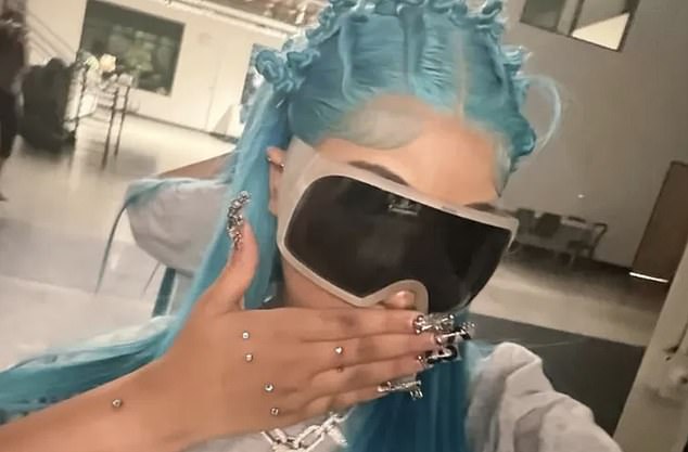 North West shows blue hair and stacked silver accessories, highlighting a faux wrist 'piercing' and finger studs in new selfies
