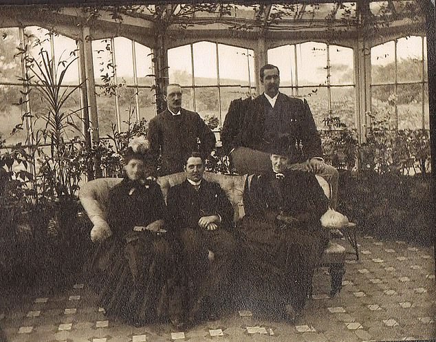 Vintage photograph of the Hopwood family in the house conservatory