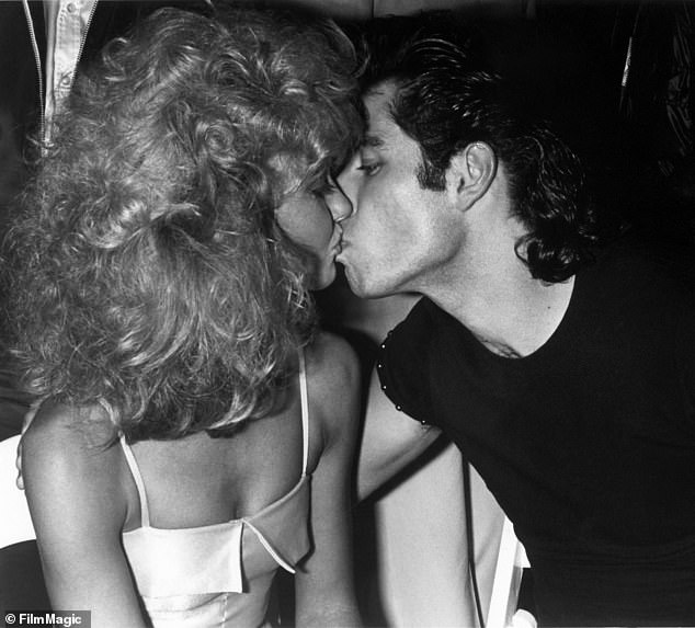 John Travolta and Olivia Newton-John share a kiss at the Grease premiere after-party at Paramount in 1978.