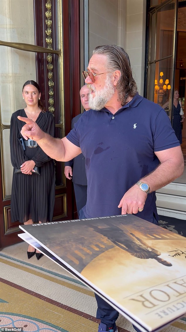 Crowe speaks firmly to fans in Paris, laying down safety rules before signing.