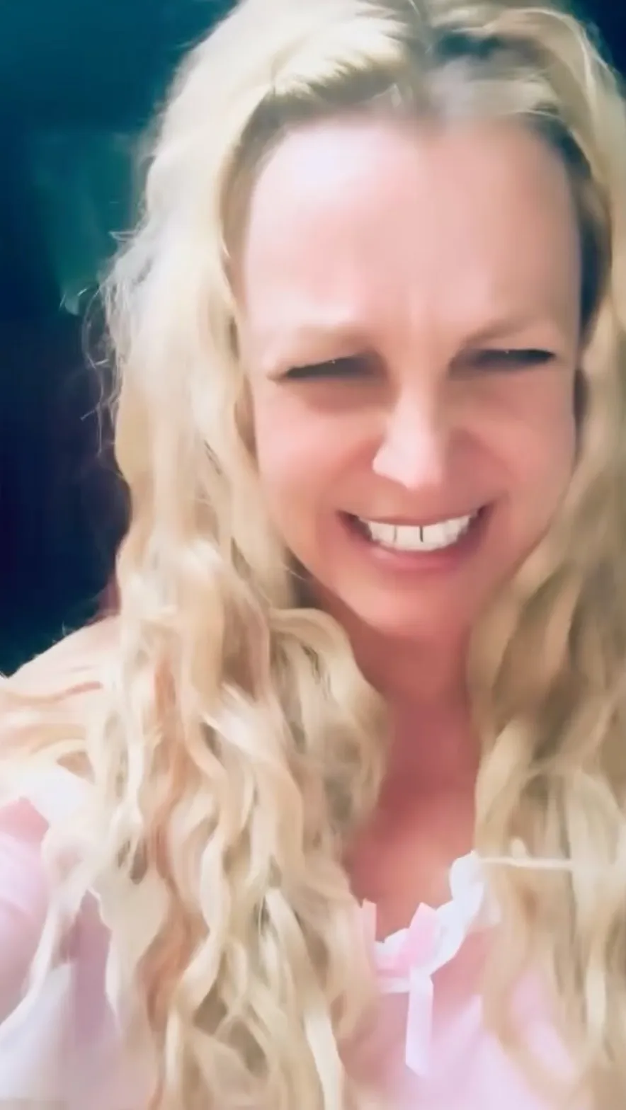 Britney Spears smiles in a pink top during a separate Instagram video where she raves about Slurpees and popcorn.
