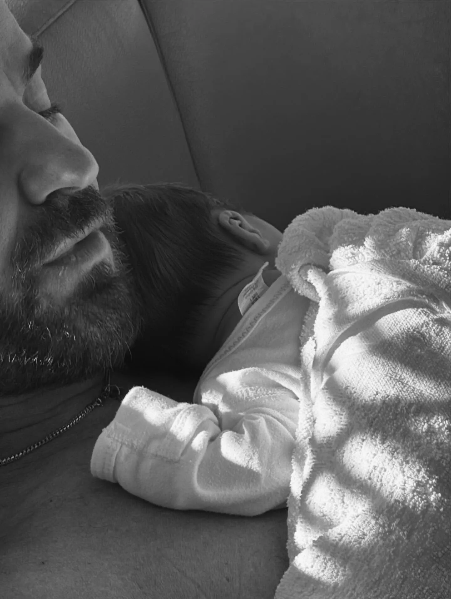 Justin Theroux with his newborn resting on his chest.