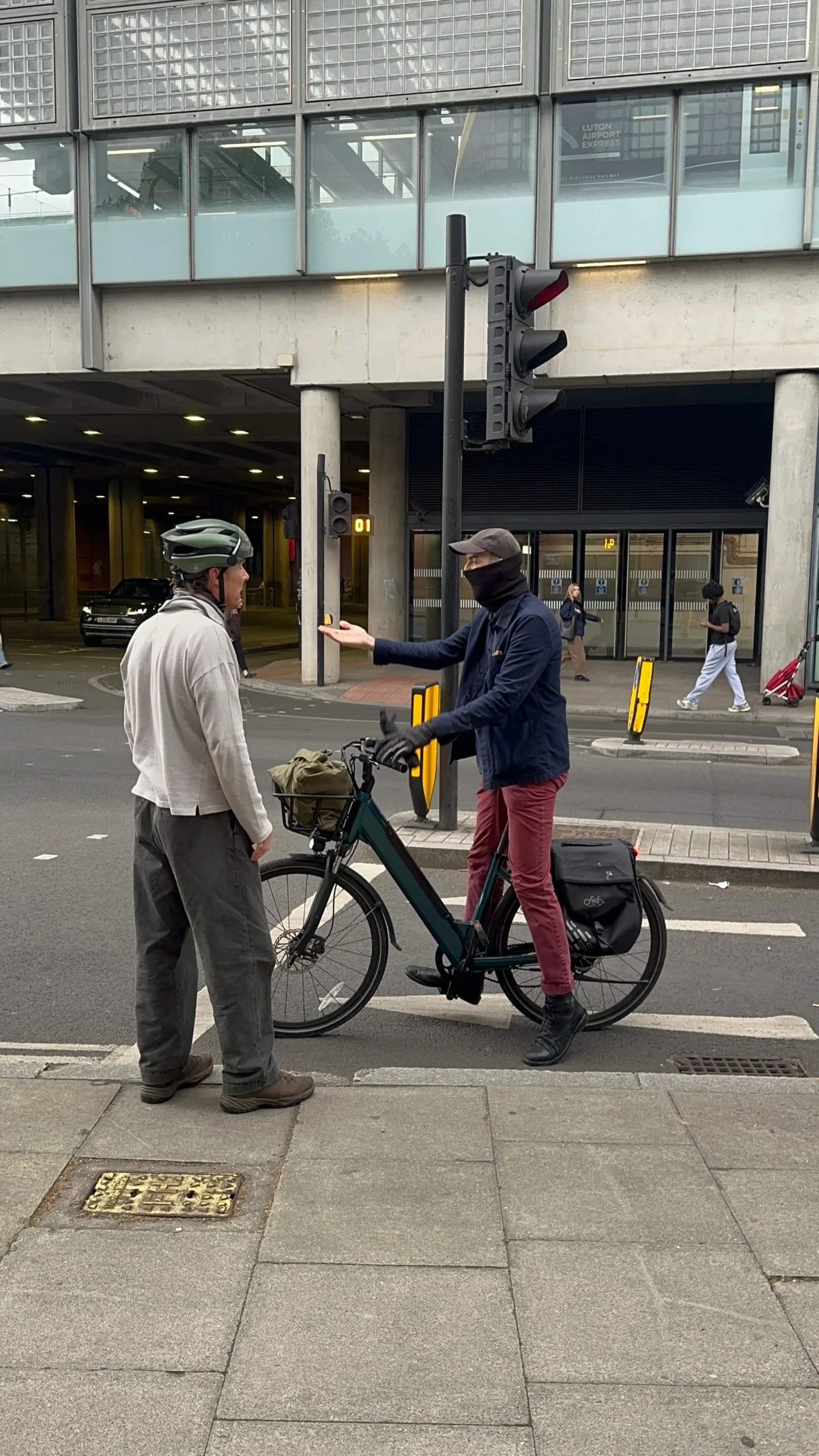The pair continue their dispute in the bike lane, briefly blocking the path, according to an onlooker.