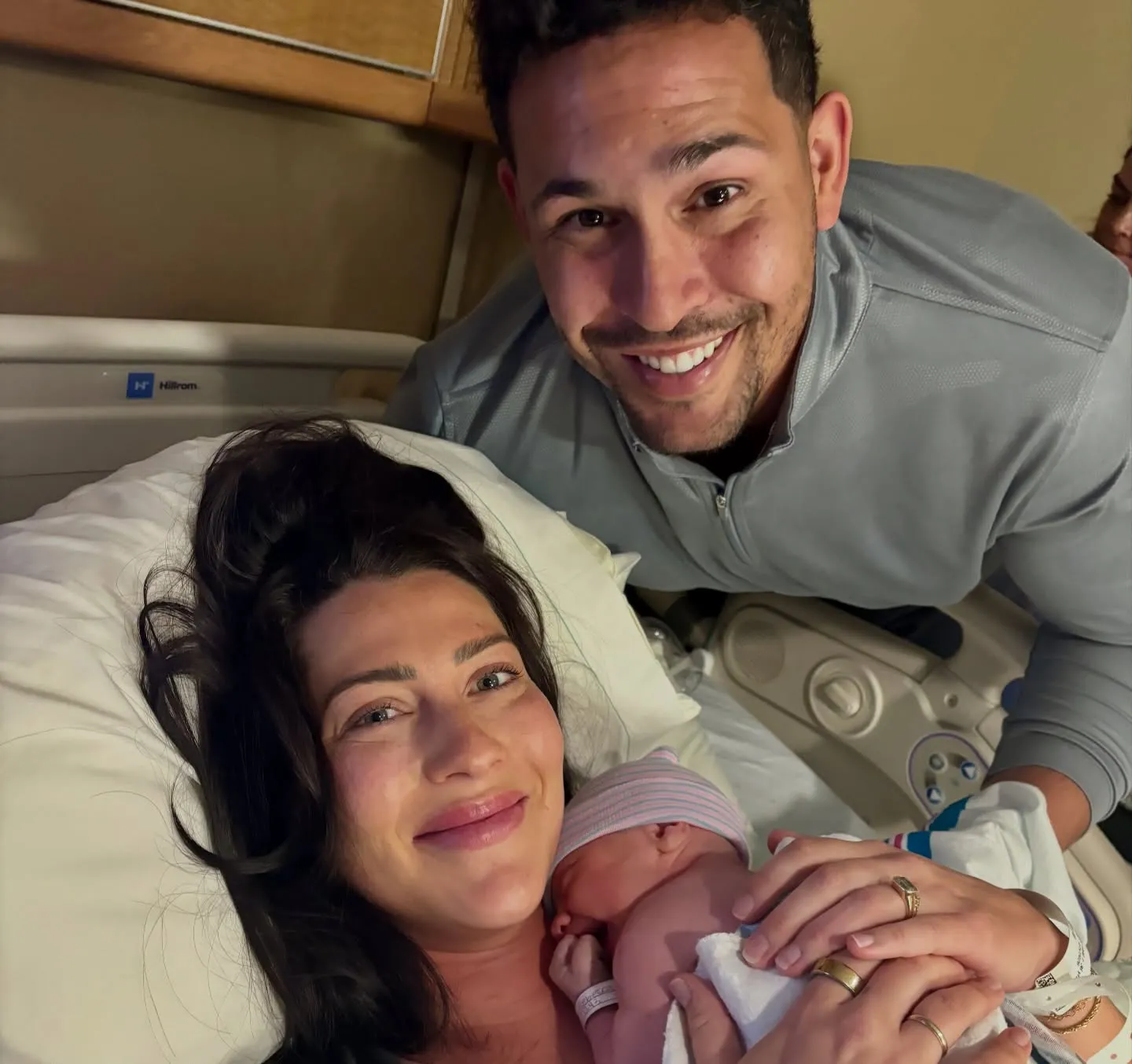Becca Kufrin and Thomas Jacobs with their newborn son.