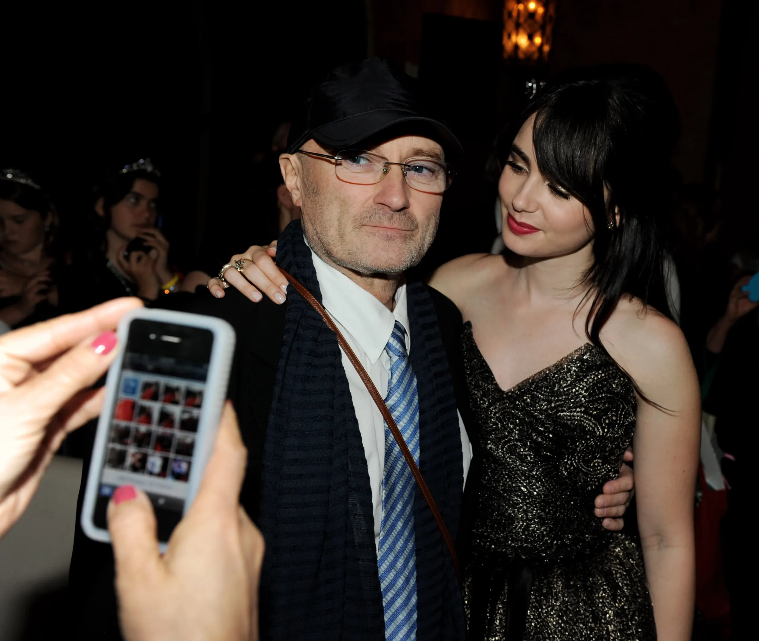 Phil Collins and Lily Collins posing for a picture at the Mirror Mirror premiere after-party.