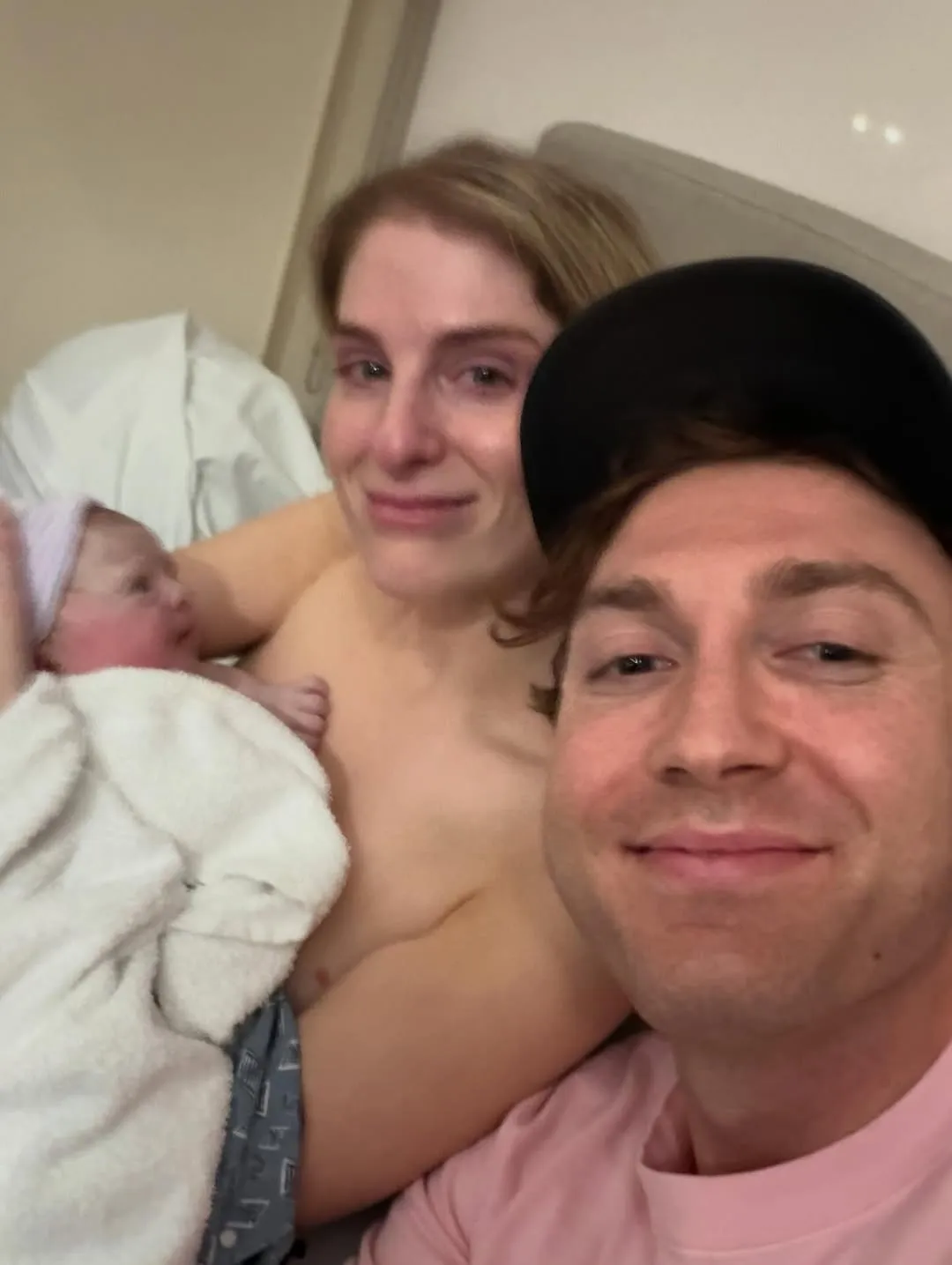 Meghan Trainor and Daryl Sabara holding their newborn daughter.