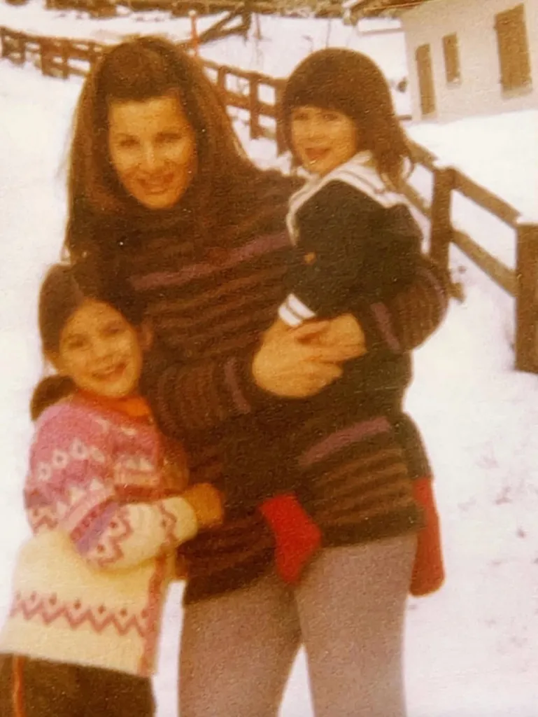 Childhood throwback of Sandra Bullock and her sister hugging their mother, Helga Meyer, in the snow.