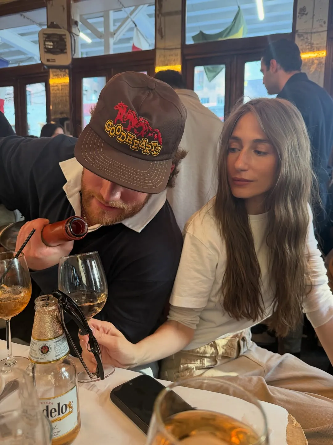 West Wilson pours wine for Amanda Batula at a restaurant.