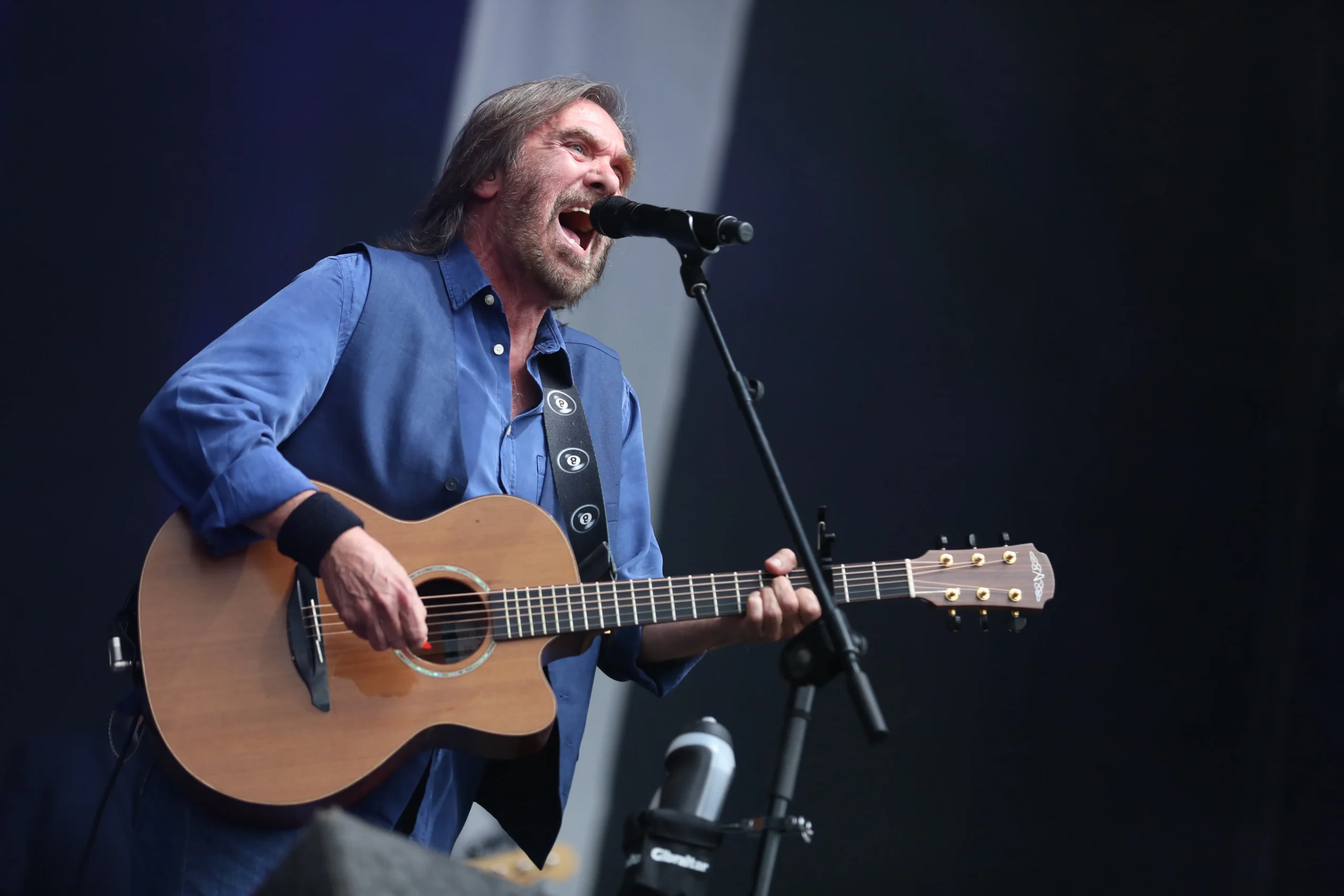 Dennis Locorriere performing in 2017 with acoustic guitar.