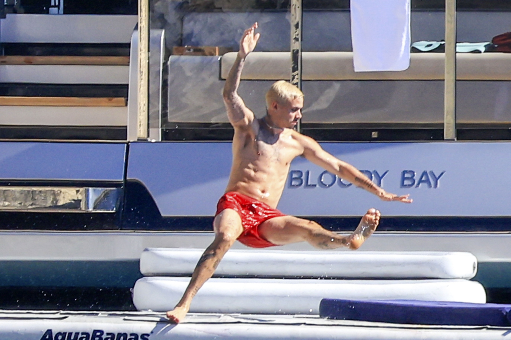 Romeo Beckham jumps from a yacht into the sea in Ibiza.