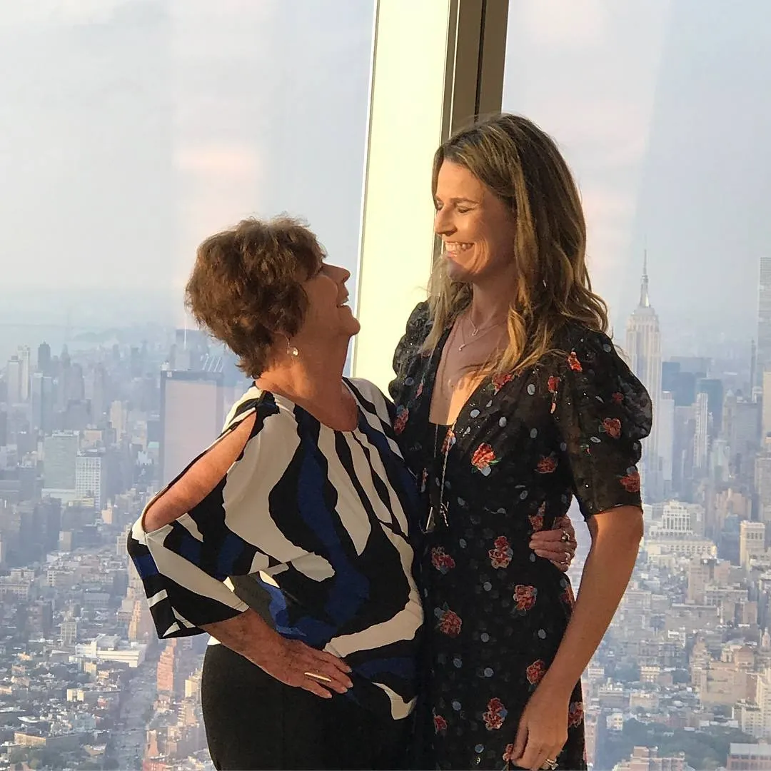 Savannah Guthrie and her mom Nancy posing for a photo with the New York City skyline in the background.