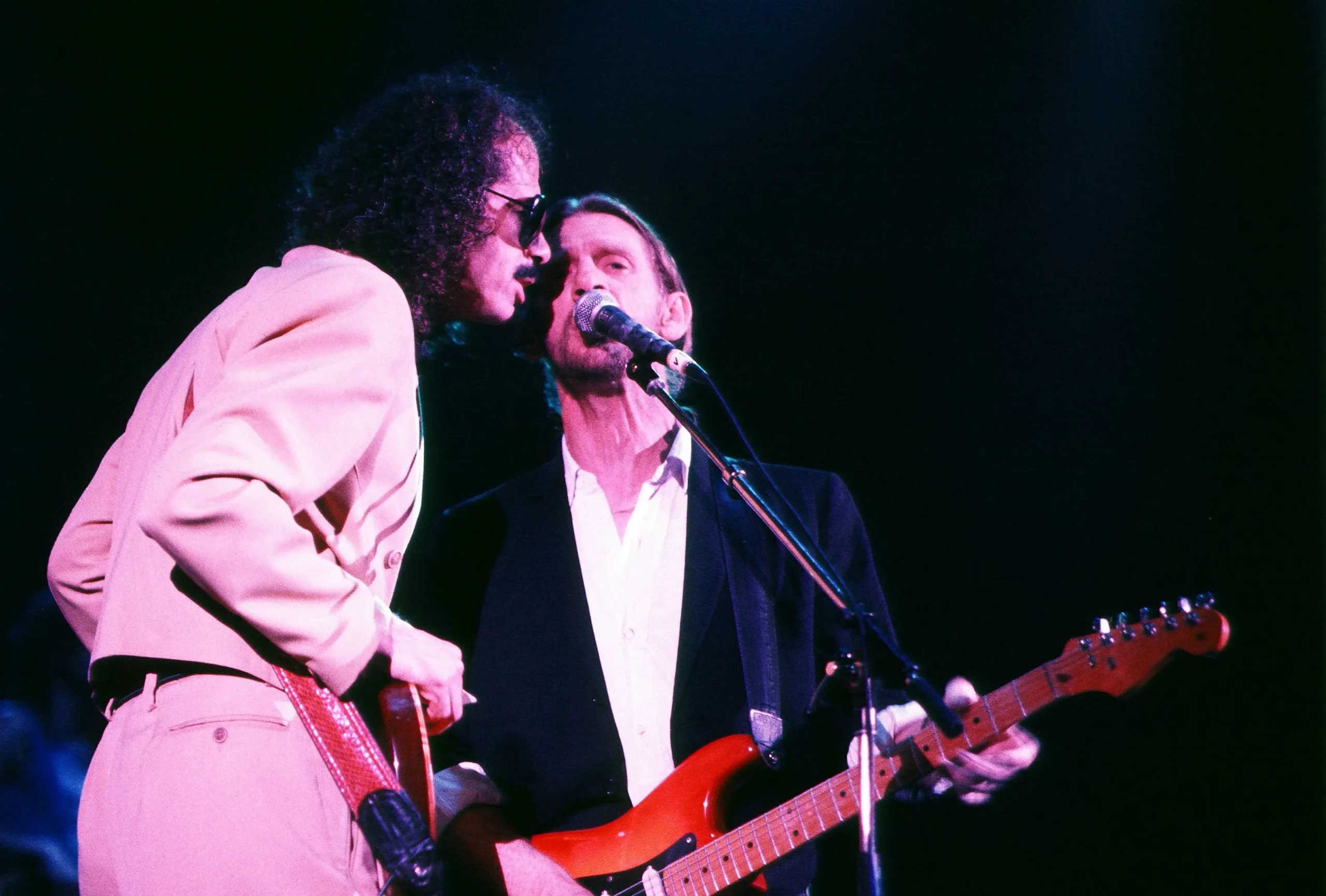 Carlos Santana and Alex Ligertwood performing live onstage.