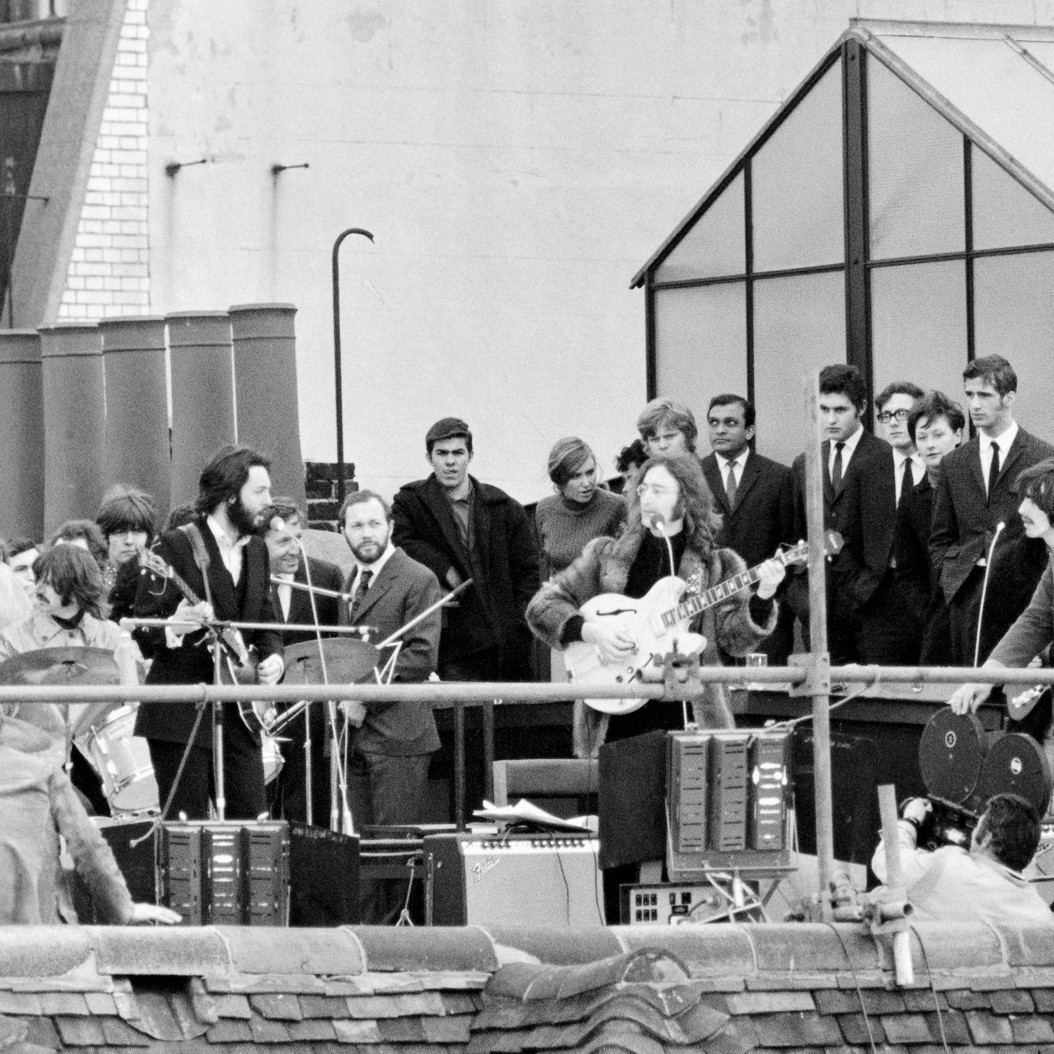 The Beatles performing on the rooftop of 3 Savile Row in 1969. - Daily Mirror/Mirrorpix via Getty Images