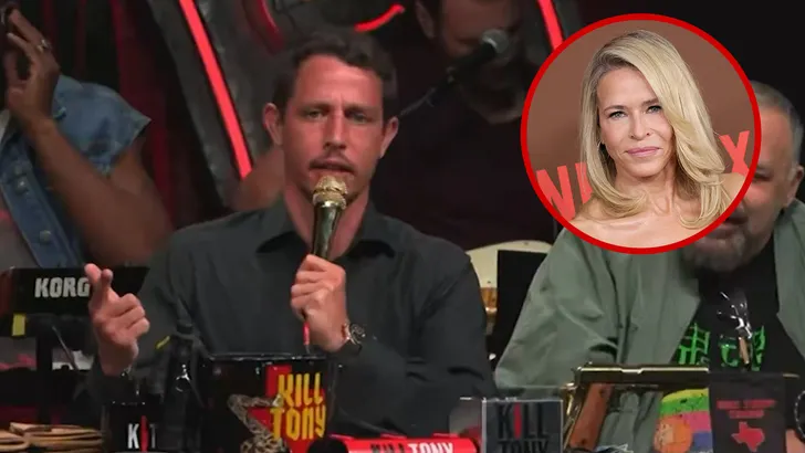 Tony Hinchcliffe at a podcast desk with a microphone.