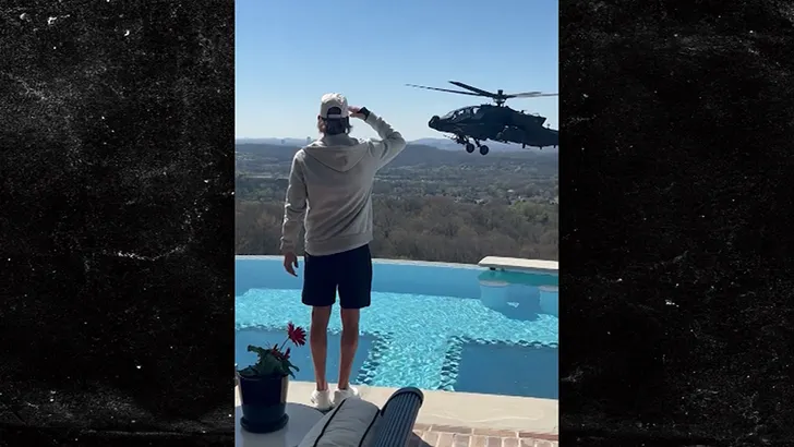 Kid Rock near a helicopter by a pool
