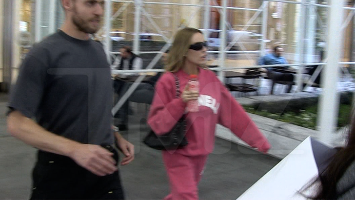 Alex Cooper quickly gets into a car as TMZ cameras approach days before her pregnancy reveal