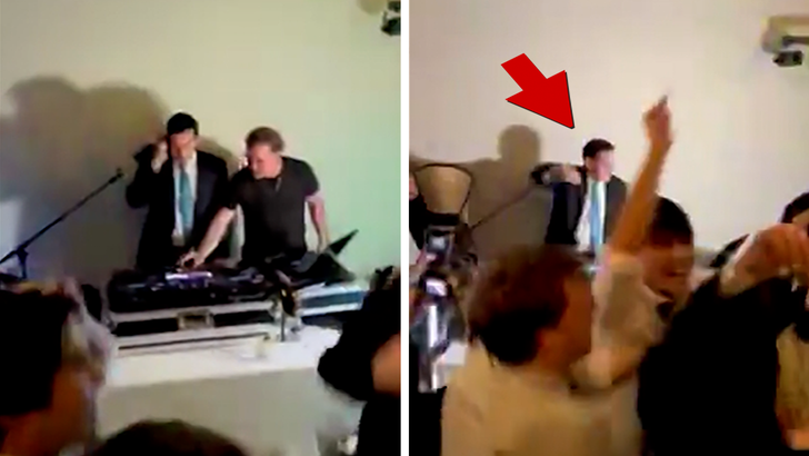 Marco Rubio at a family wedding DJ booth wearing headphones and gesturing toward the mixer
