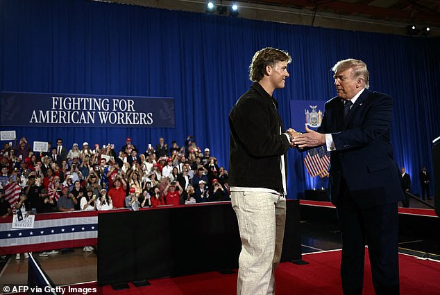 Jaxson Dart shakes hands with Donald Trump on stage at the Suffern, New York rally