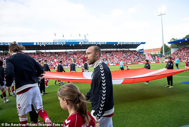 Eriksen walks out with his Denmark team-mates before yesterday's match against Ukraine in Odense
