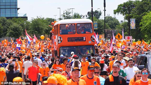 Netherlands supporters in a sea of orange chant and dance during a Texas fan gathering