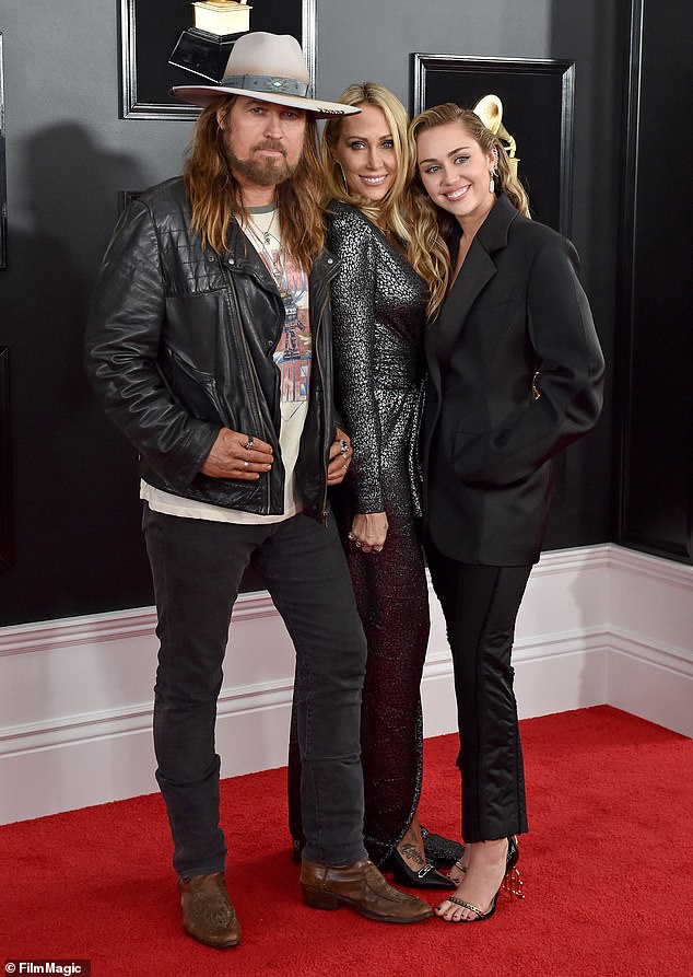 Miley Cyrus with Billy Ray and Tish Cyrus on a red carpet, years before the family rift