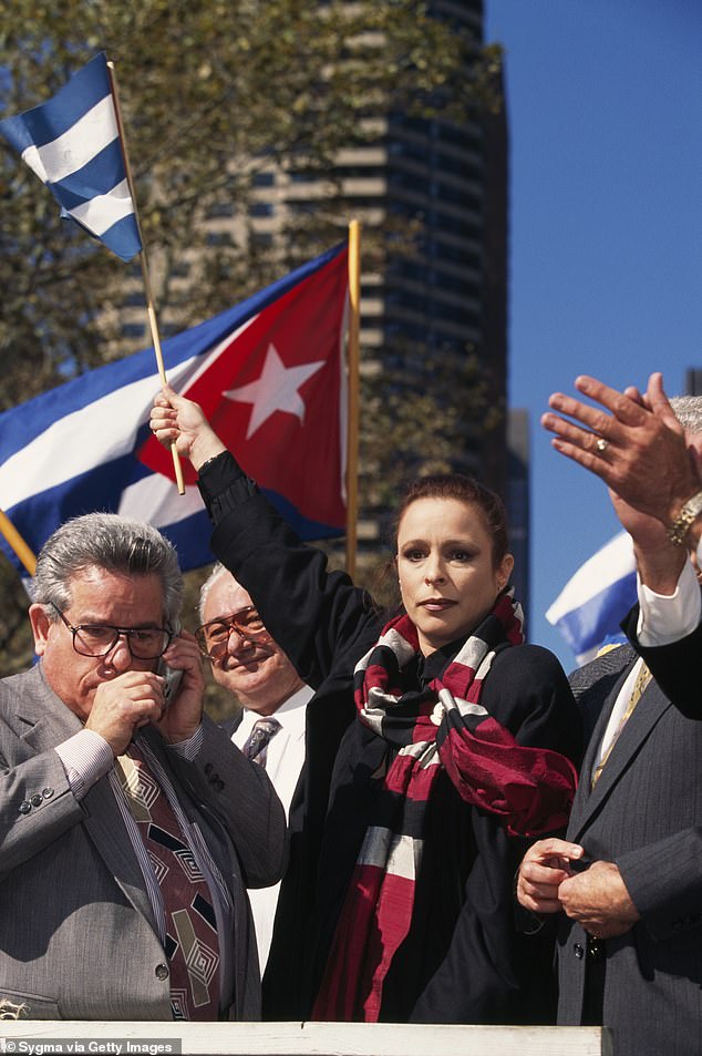 Alina Fernandez protesting against her father's regime, holding a Cuban flag