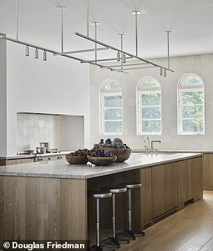Minimalist, high-end kitchen in the Bezos family home with hidden technology and seamless finishes