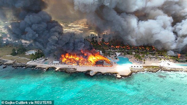 Aerial view of the Viva Dominicus Beach by Wyndham resort as a massive fire sends smoke over Bayahibe, Dominican Republic.