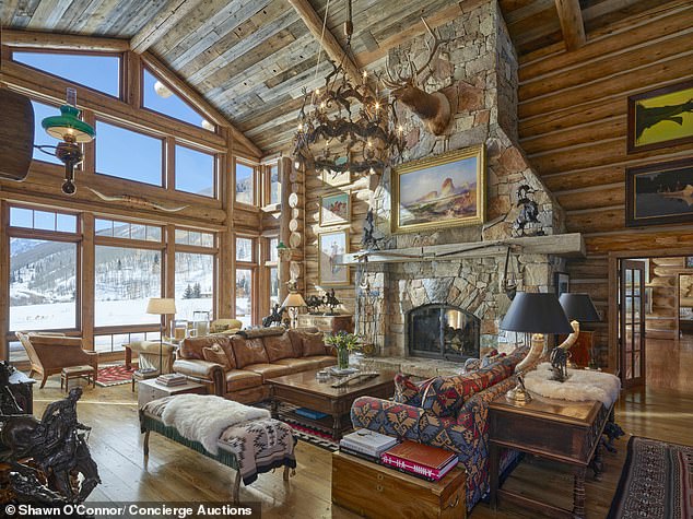 Grand living room at Elk Mountain Lodge with fireplace and mountain views