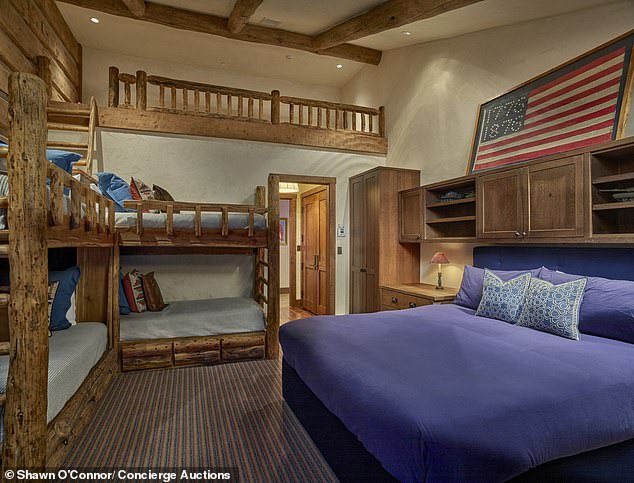 Multi-level children's bunk room with rustic wood paneling