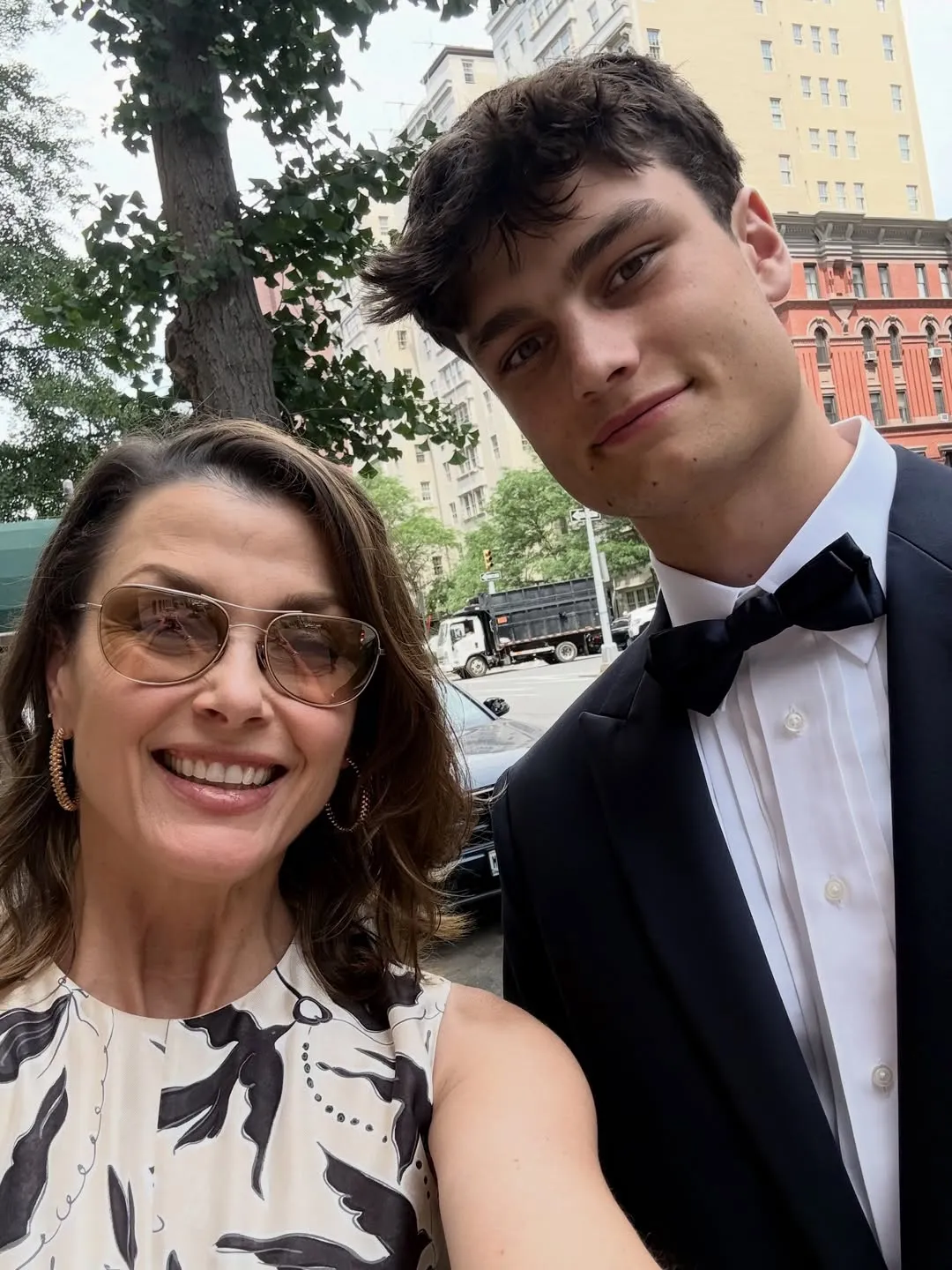 Bridget Moynahan taking a selfie with her son Jack, who is dressed in a suit and bow tie.