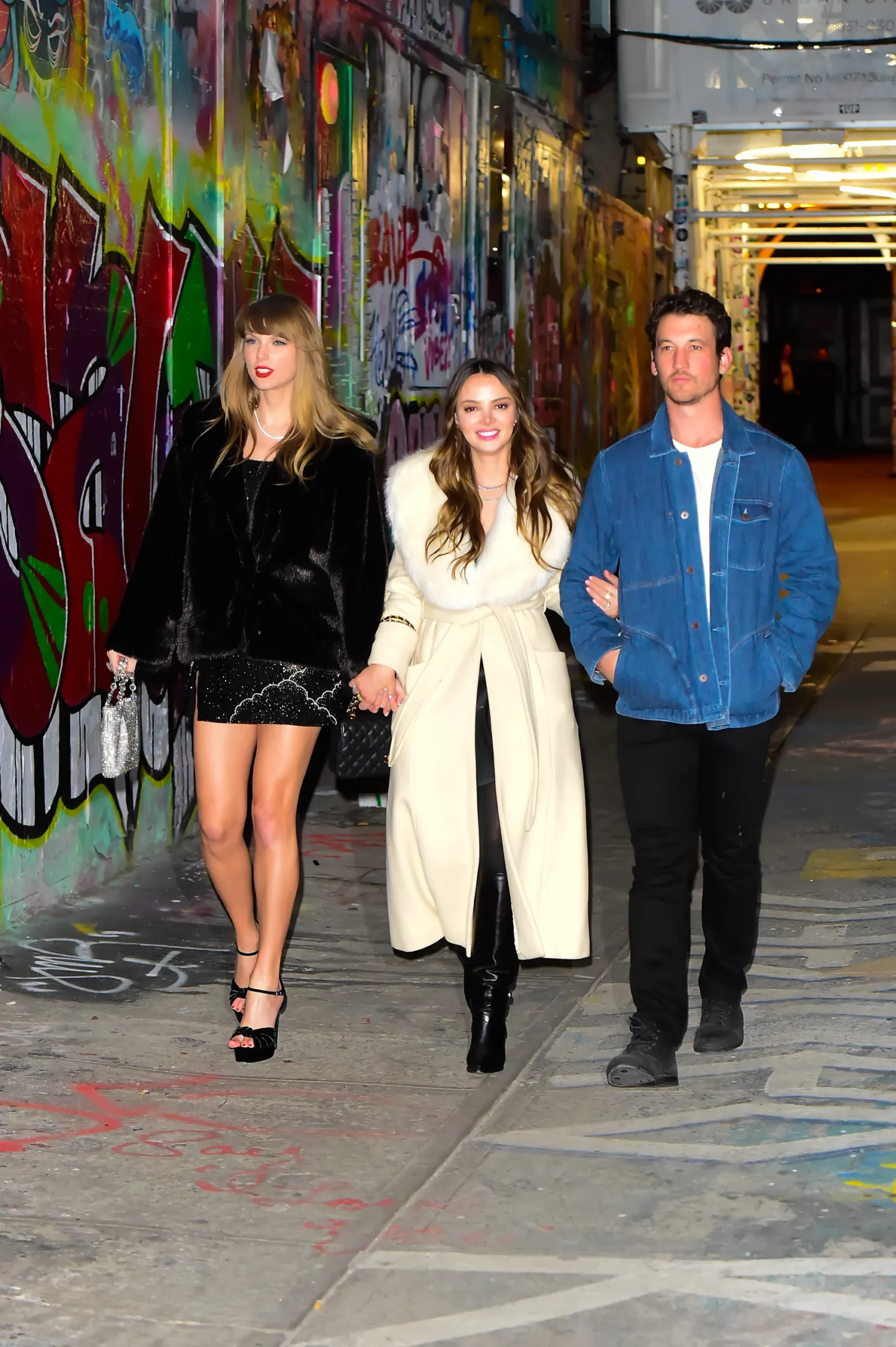 Taylor Swift walks with Keleigh Sperry and Miles Teller in New York City, December 2023.