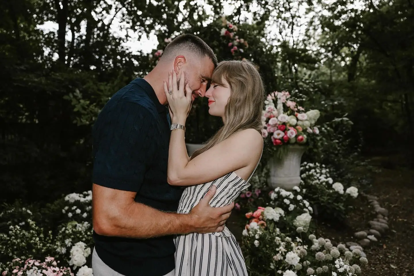 Taylor Swift and Travis Kelce embrace as she shows her engagement ring.