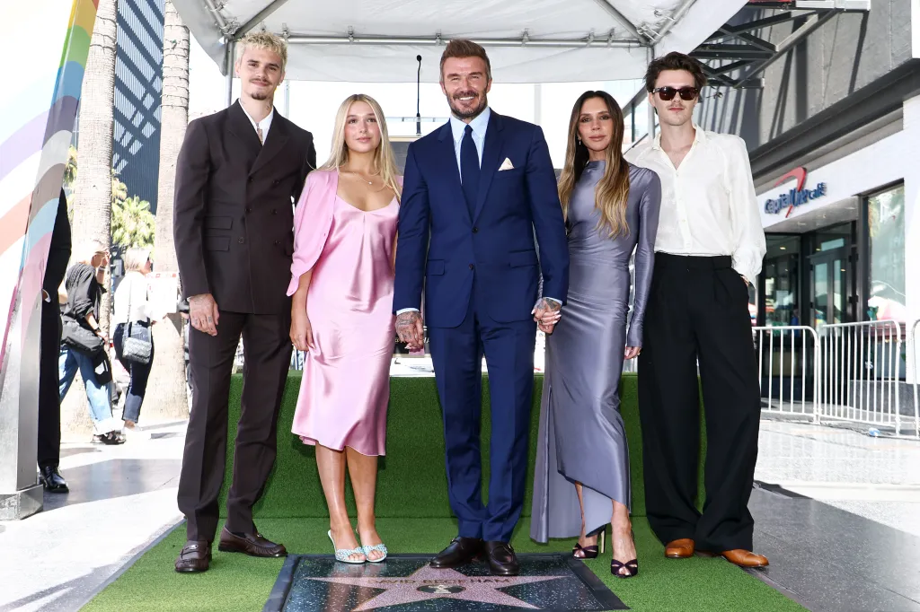 David Beckham stands with his children Romeo, Harper, Cruz, and wife Victoria beside his Hollywood Walk of Fame star.
