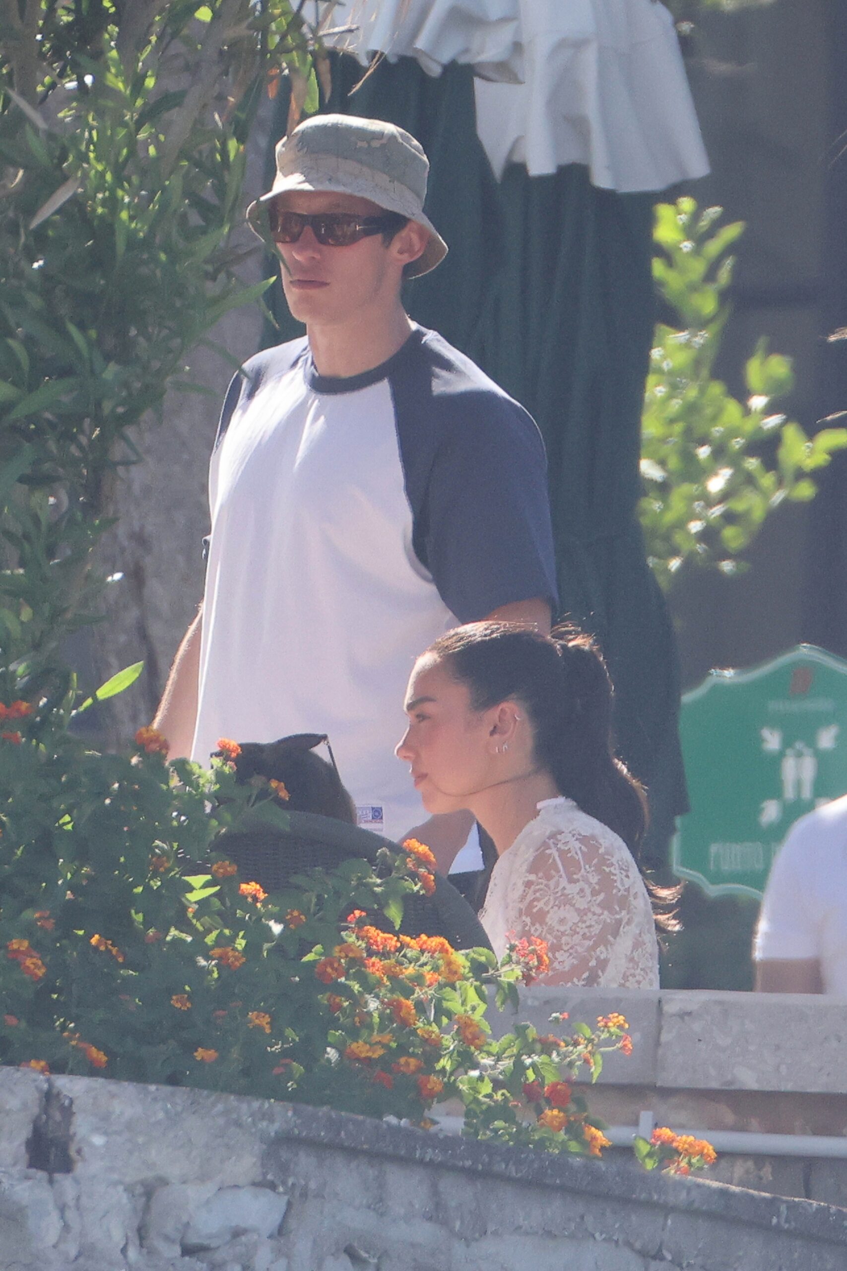 Dua Lipa and Callum Turner attending a post-wedding gathering.
