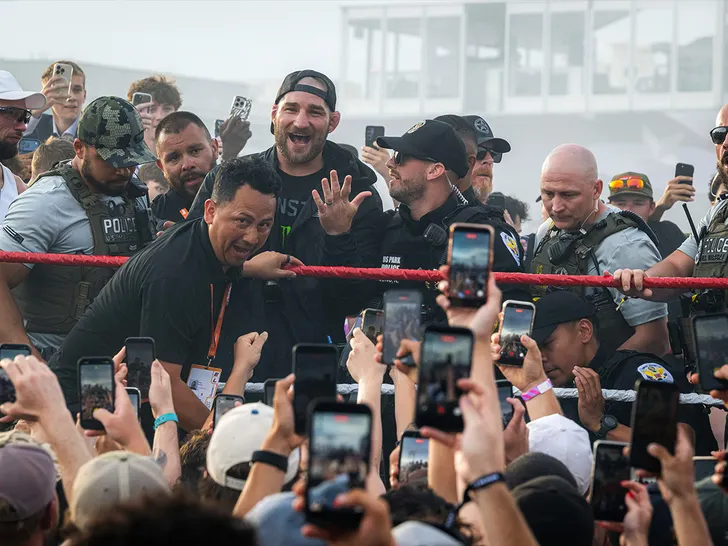 Sean Strickland inside the octagon as fans record with their phones